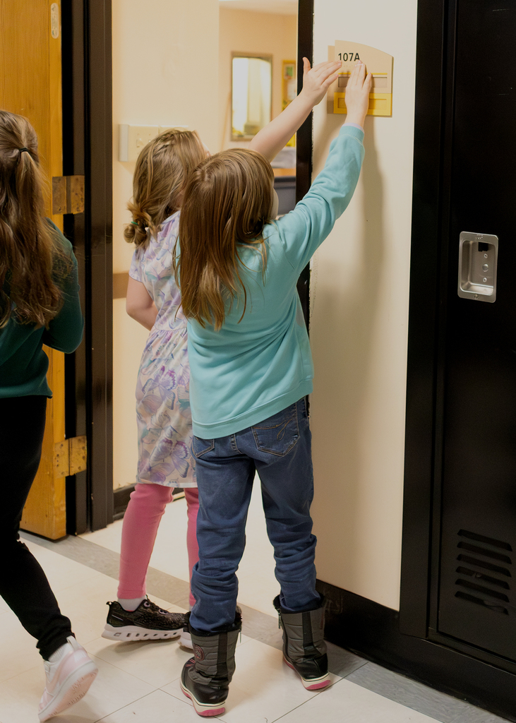 Students learning about Braille