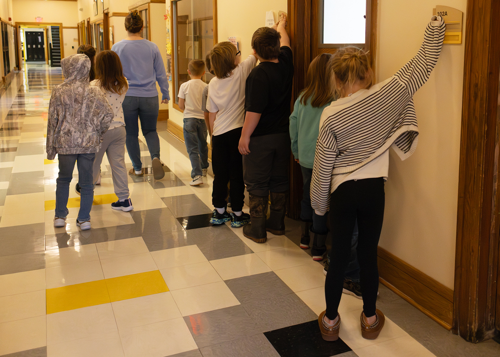 Students learning about Braille