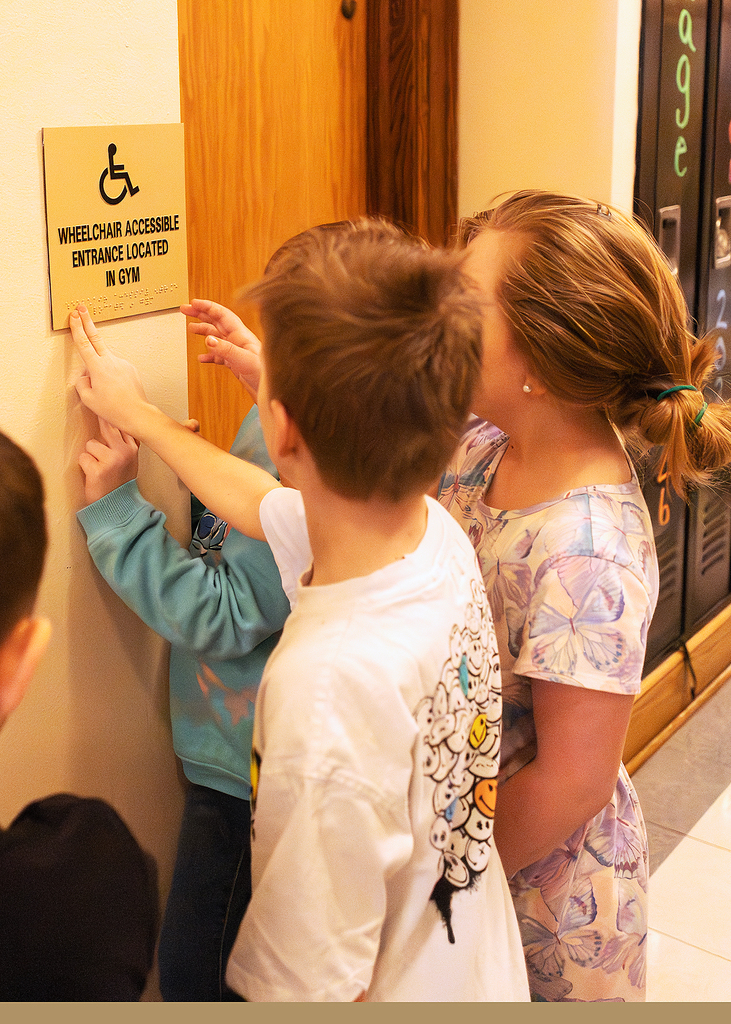 Students learning about Braille