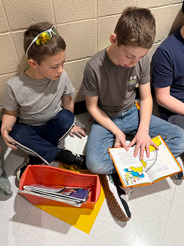 Otselic Valley students reading books together during Buddy Reading for Read Across America Week.