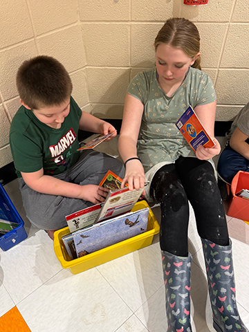 Otselic Valley students reading books together during Buddy Reading for Read Across America Week.