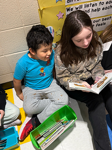 Otselic Valley students reading books together during Buddy Reading for Read Across America Week.