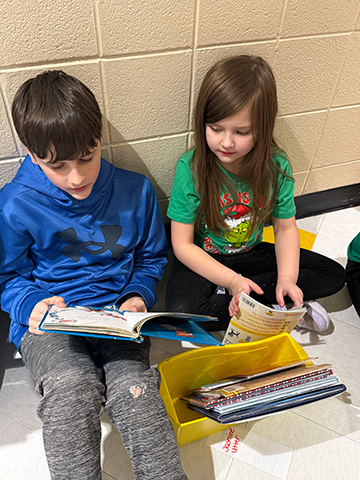 Otselic Valley students reading books together during Buddy Reading for Read Across America Week.