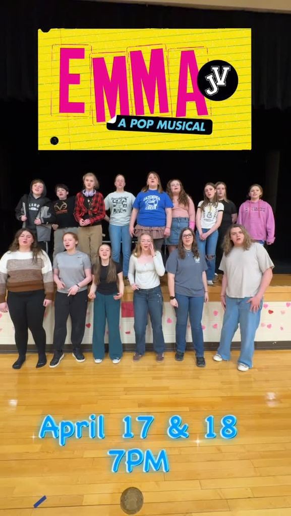 Image of cast of spring musical Emma in front of stage