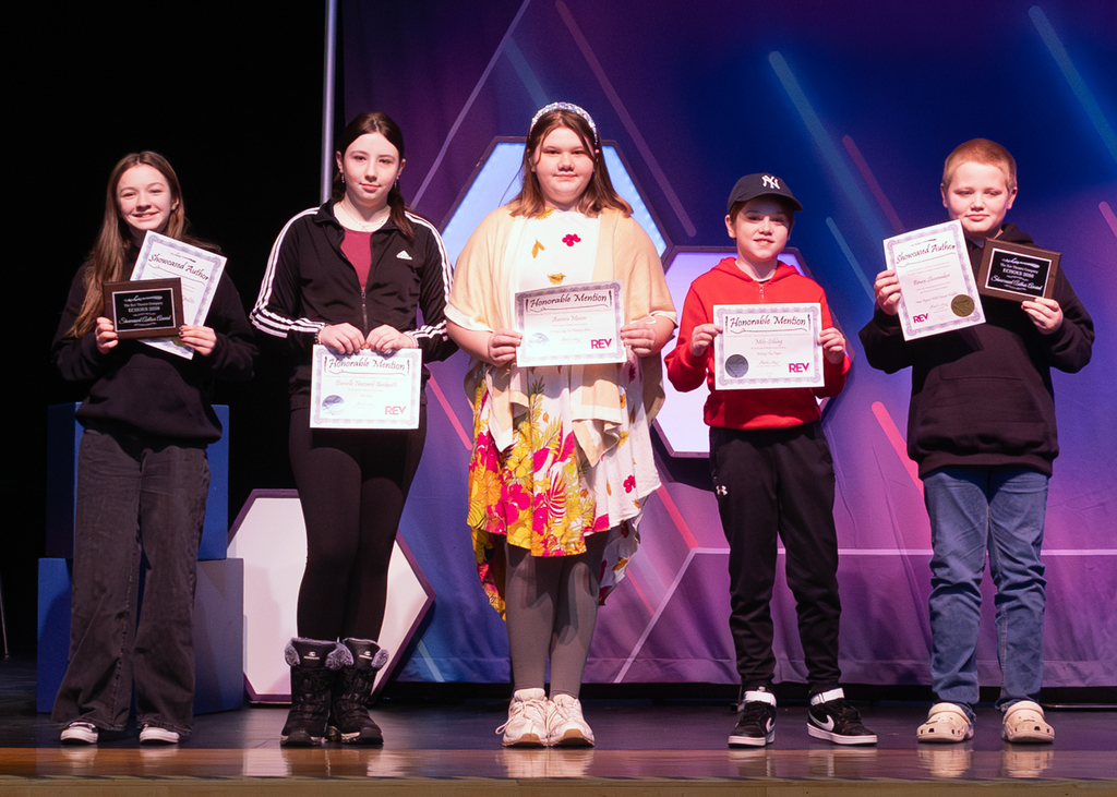 OV Winners on stage holding their certificates 