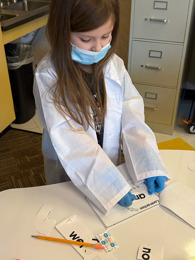 A first grade student performs contraction surgery