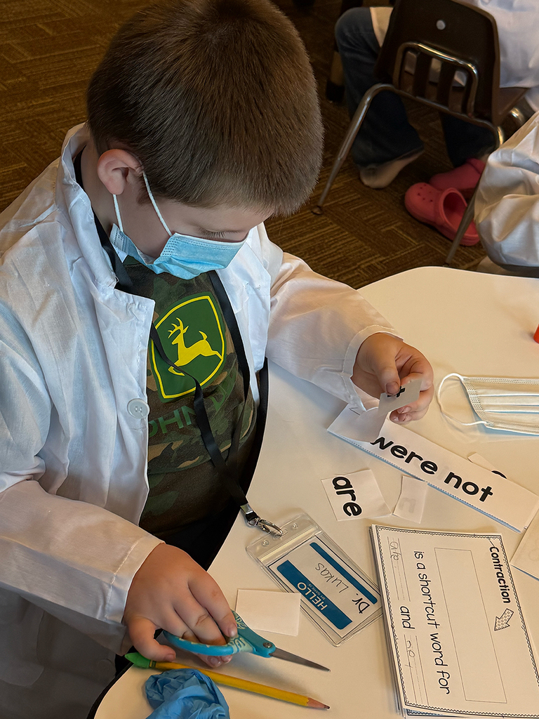 A first grade student performs contraction surgery