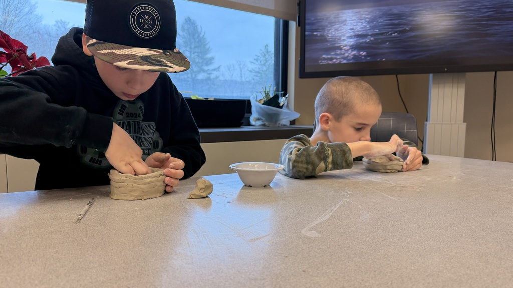 Students work on the clay pots