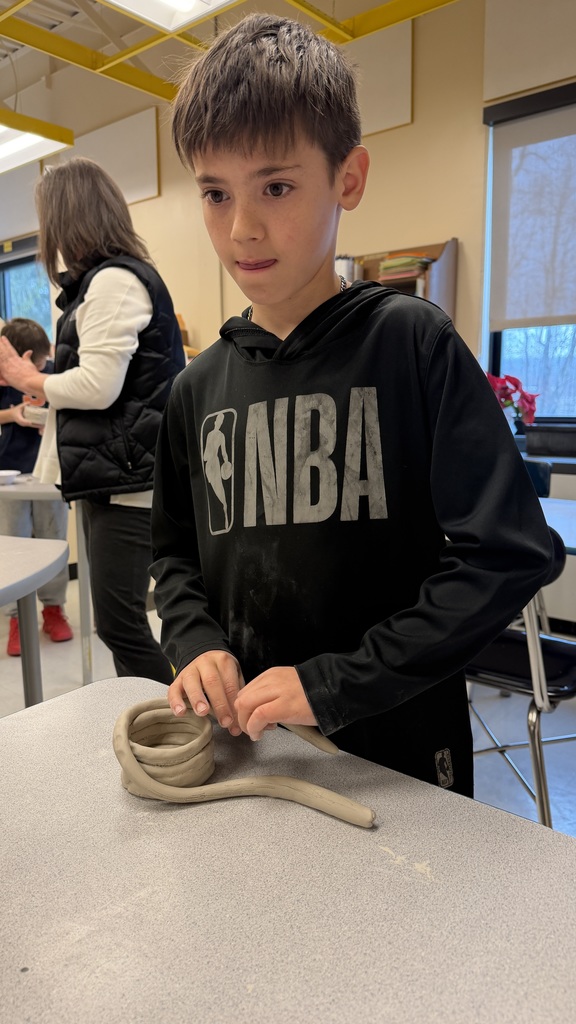 Students work on the clay pots