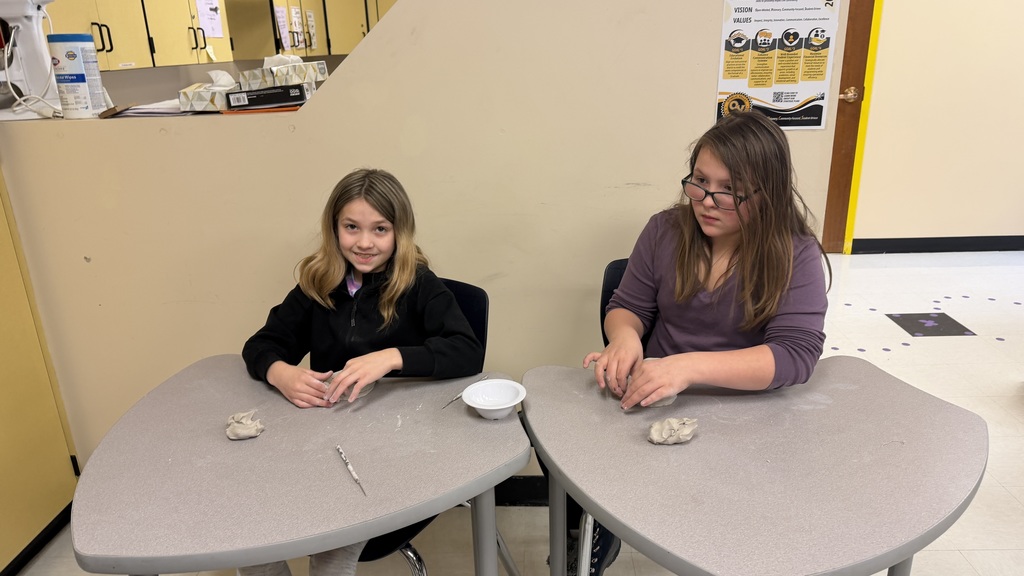 Students work on the clay pots