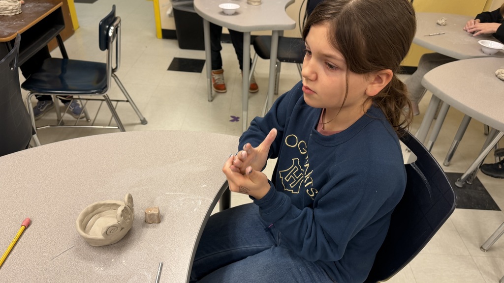 Students work on the clay pots