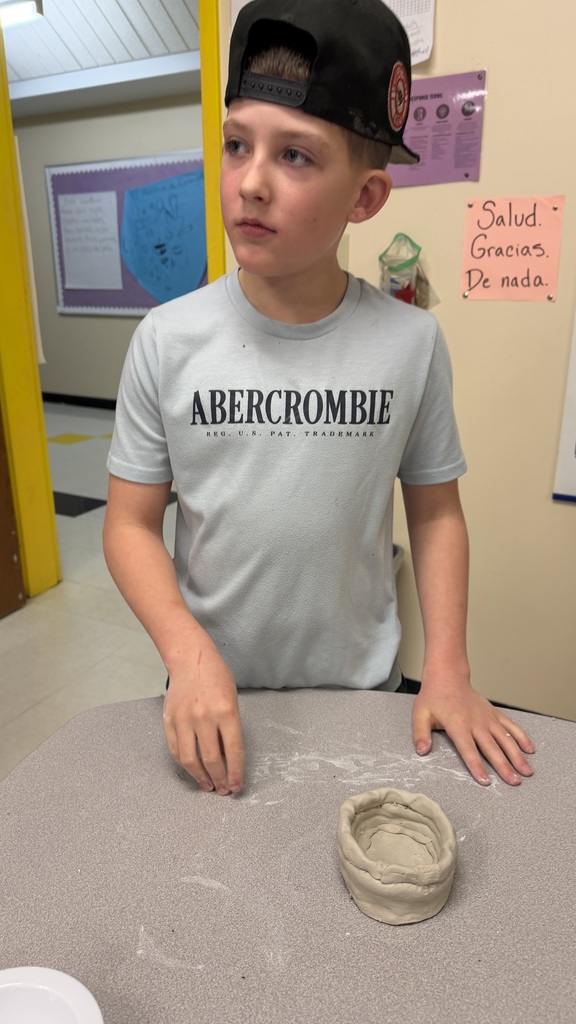 Students work on the clay pots