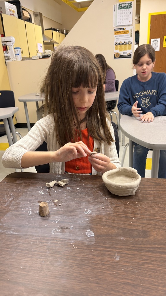 Students work on the clay pots