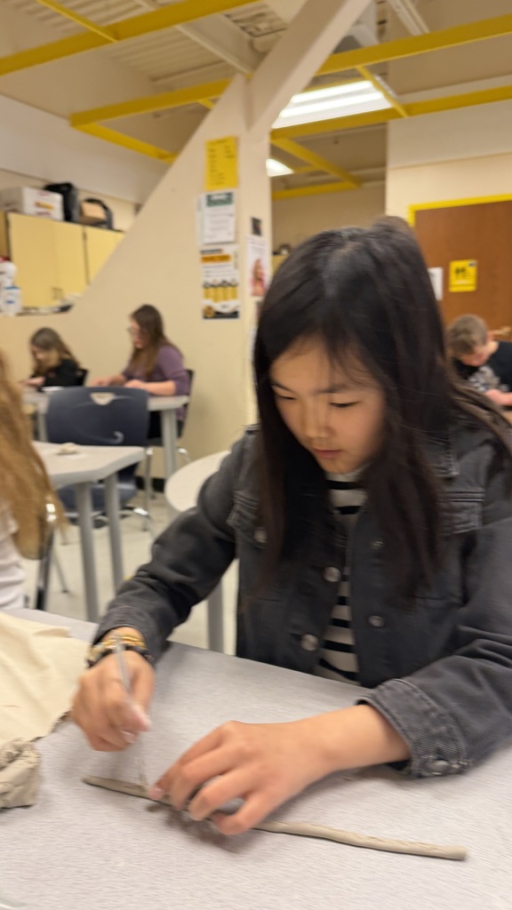 Students work on the clay pots