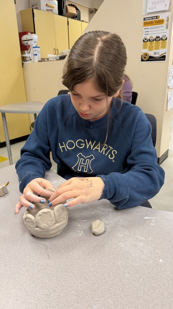 Students work on the clay pots
