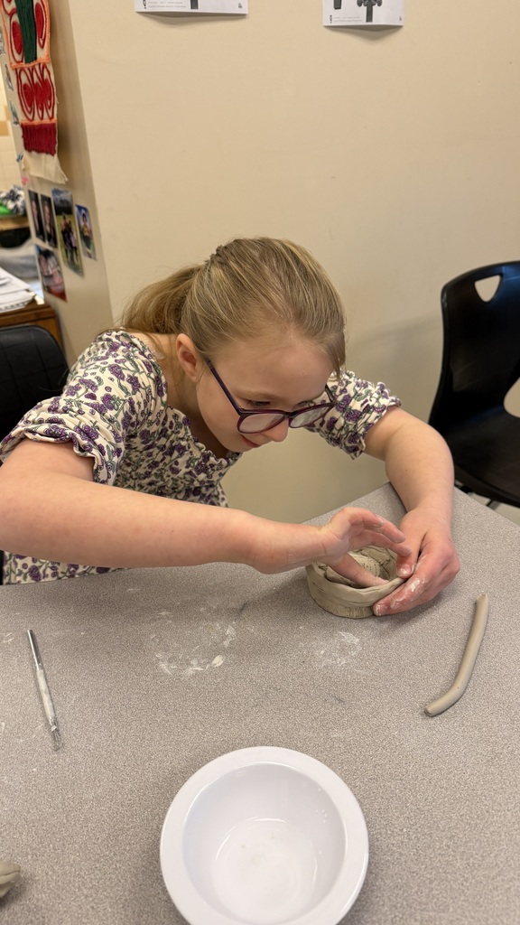 Students work on the clay pots