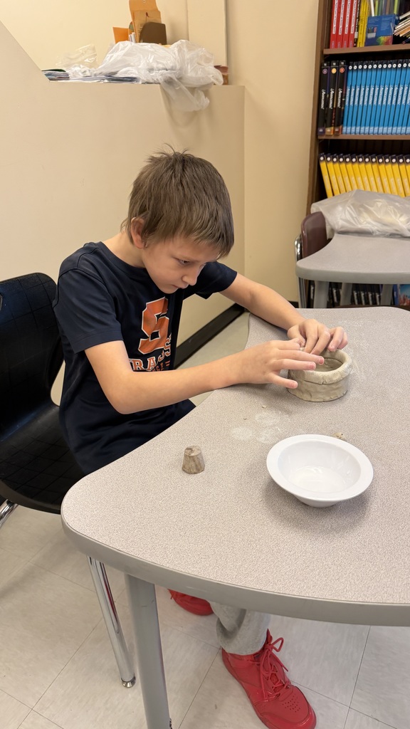 Students work on the clay pots