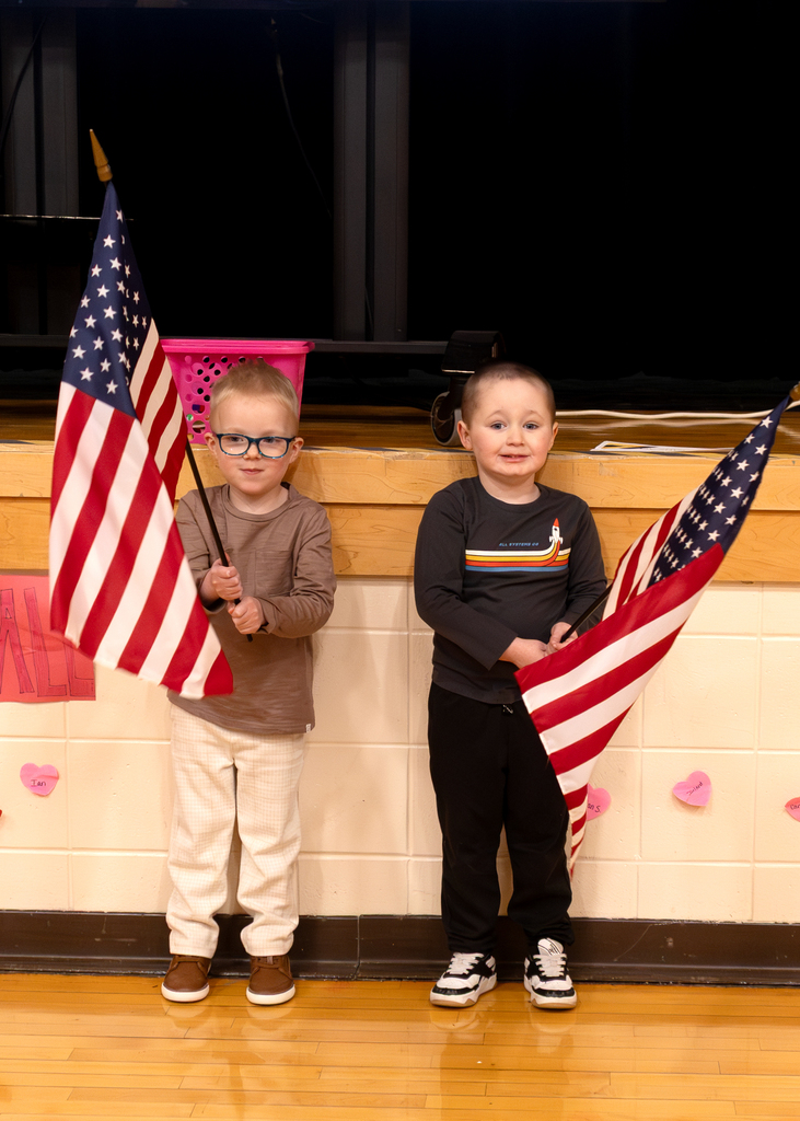 Flag bearers standing in front of the stage