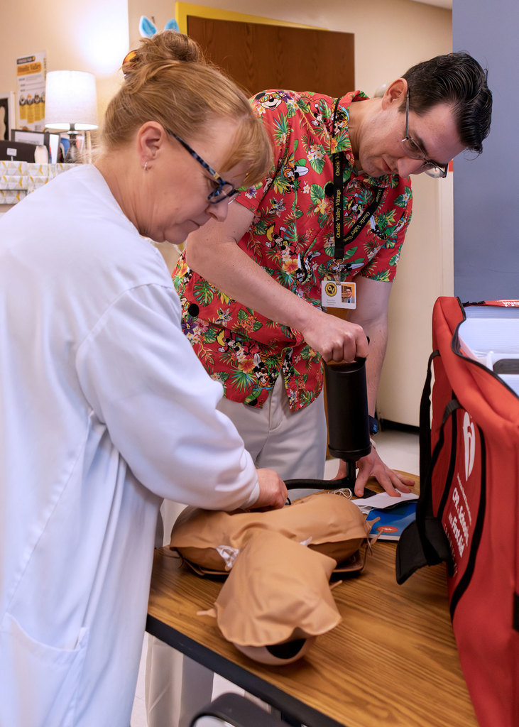 Otselic Valley School Nurse Stacie Morse and Superintendent Brian Collier inflate a CPR training mannequin from the new CPR in Schools training kit provided by the American Heart Association and Visions Federal Credit Union.