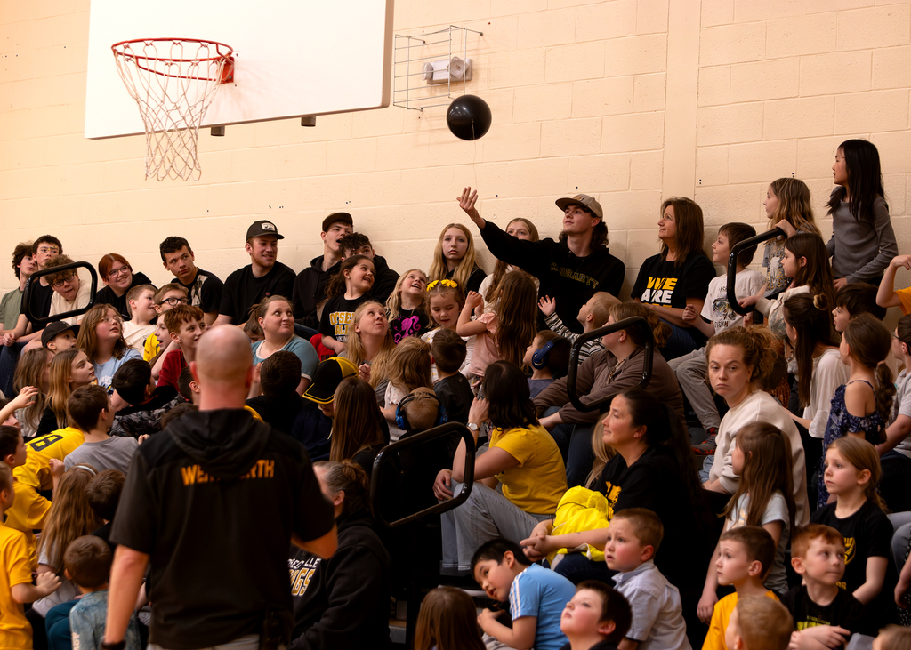 The crowd keeps a balloon in the air
