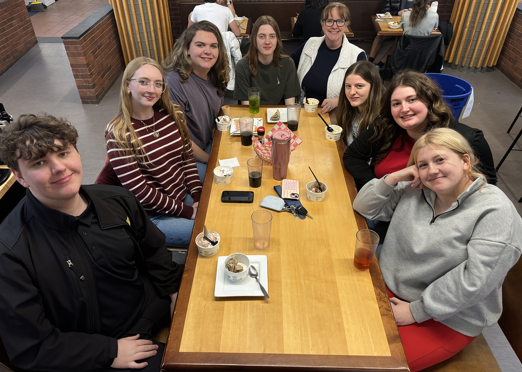 Students sitting around a table in the dining hall