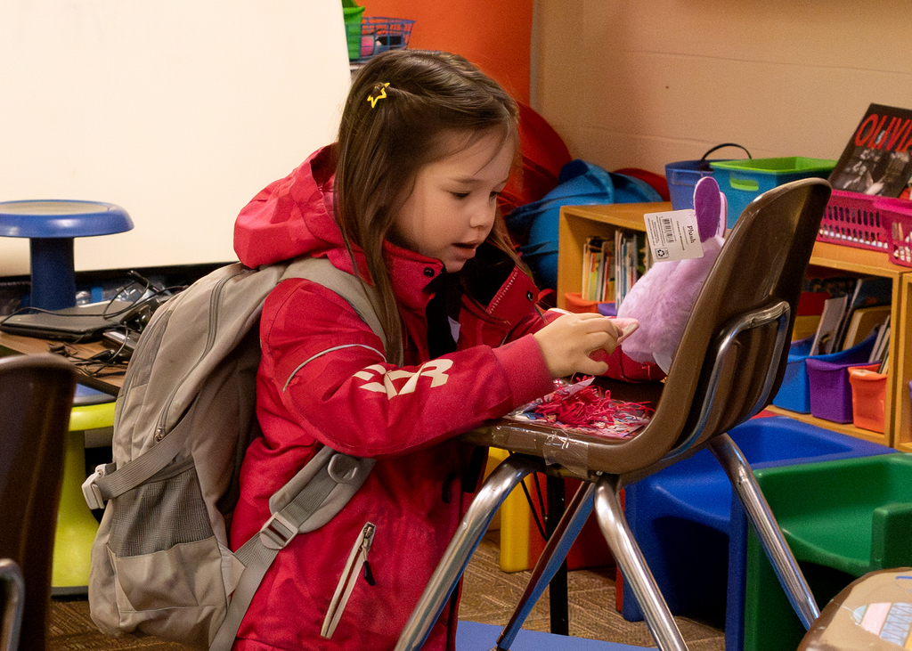 A student admires what her egg hatched into