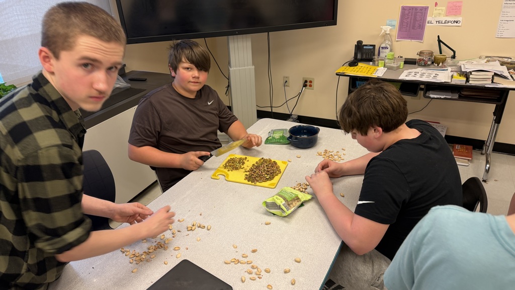 Students in a 6th grade cooking class prepare and assemble chocolate strawberry dessert cups 