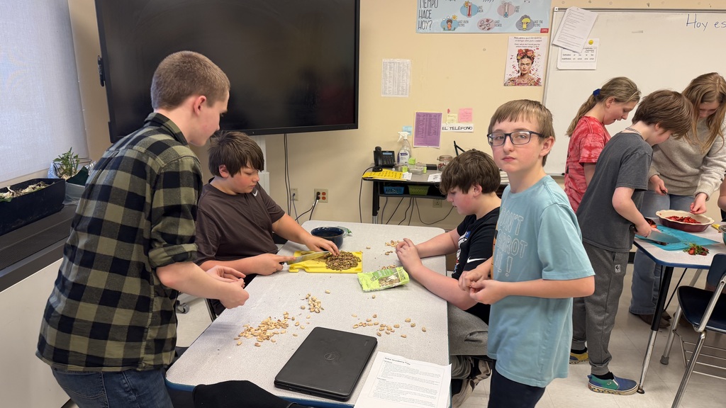Students in a 6th grade cooking class prepare and assemble chocolate strawberry dessert cups 