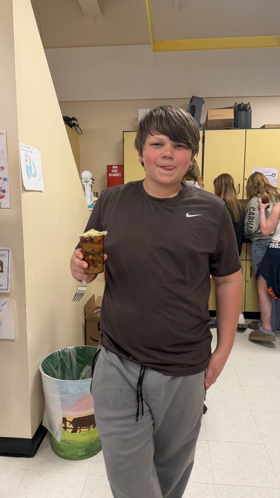 Students in a 6th grade cooking class prepare and assemble chocolate strawberry dessert cups 