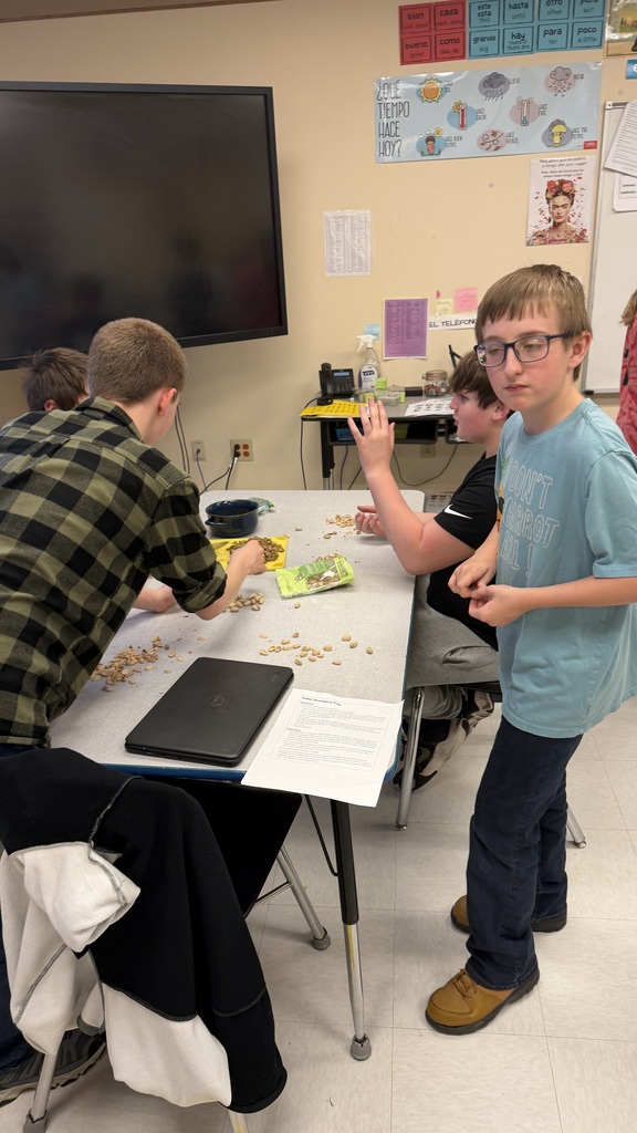 Students in a 6th grade cooking class prepare and assemble chocolate strawberry dessert cups 
