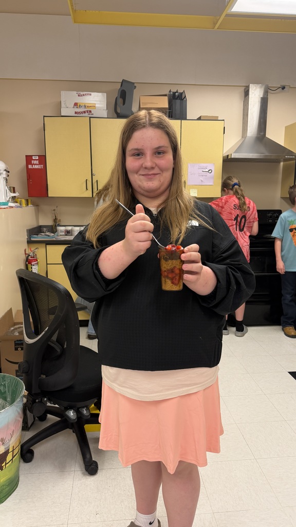 Students in a 6th grade cooking class prepare and assemble chocolate strawberry dessert cups 