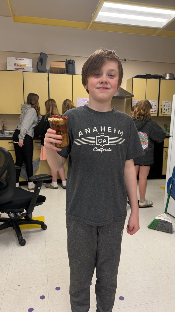 Students in a 6th grade cooking class prepare and assemble chocolate strawberry dessert cups 