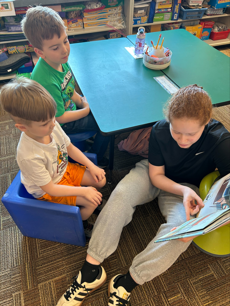 Student actors perform and read books about bravery to elementary students during a classroom visit.