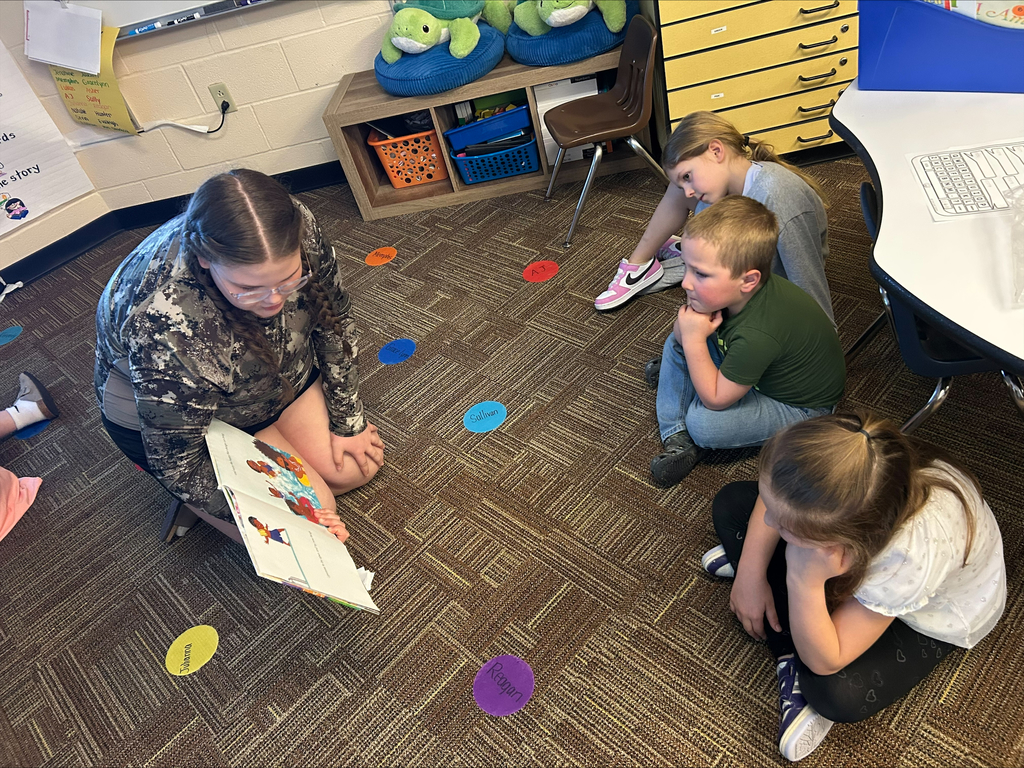 Student actors perform and read books about bravery to elementary students during a classroom visit.
