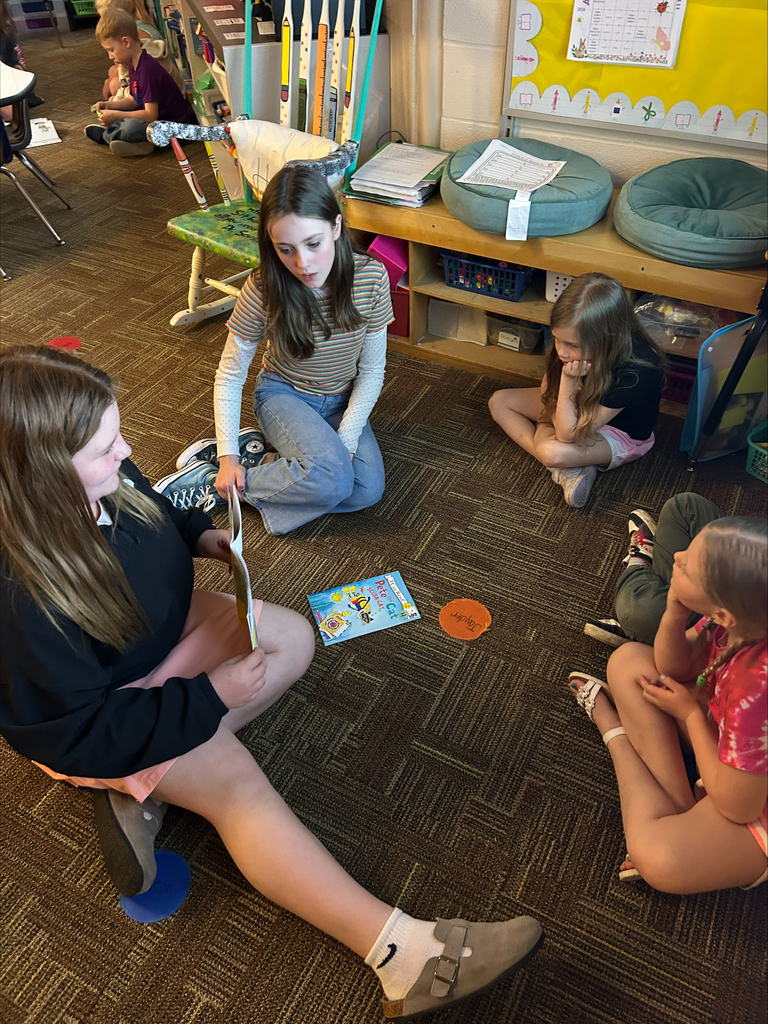 Student actors perform and read books about bravery to elementary students during a classroom visit.