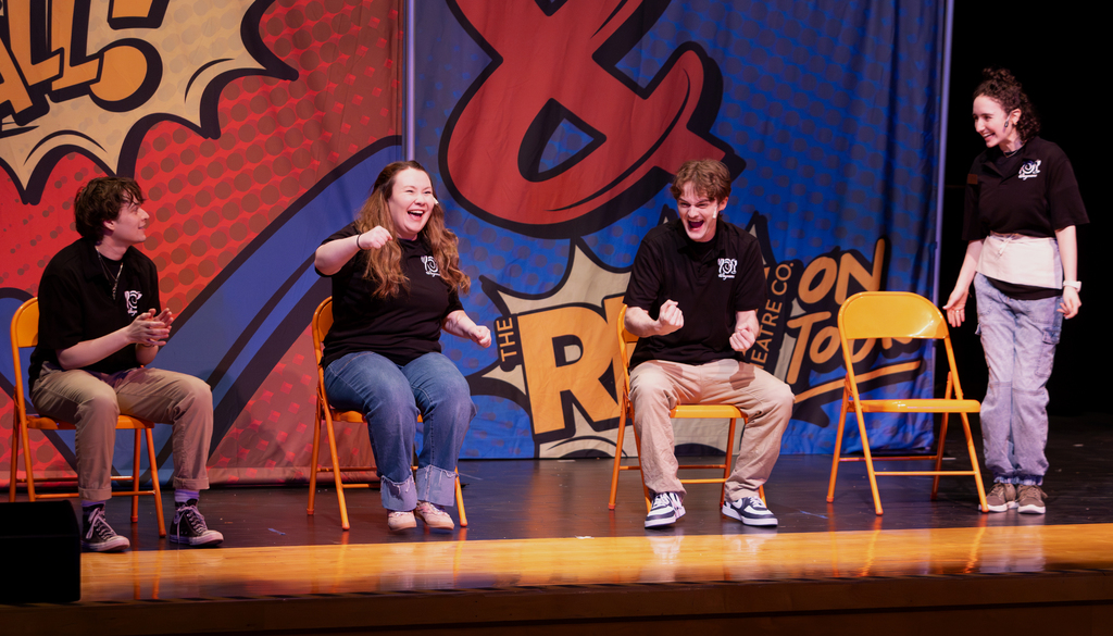 The REV cast on stage performing