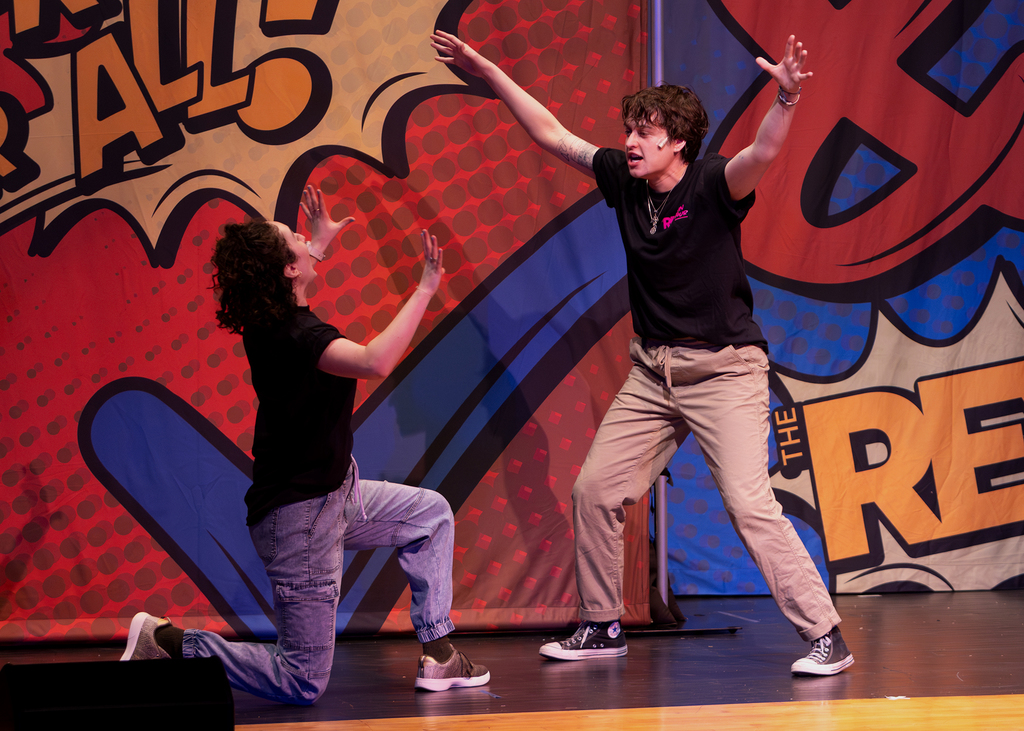 The REV cast on stage performing