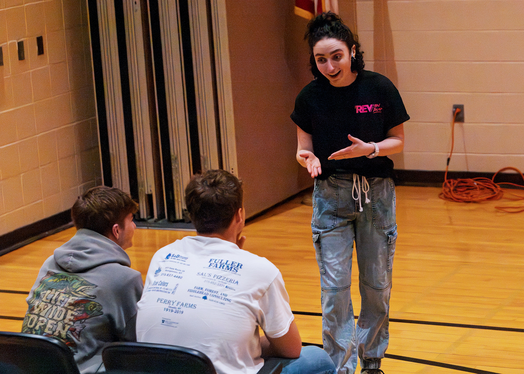 A REV Theatre performer talks to students