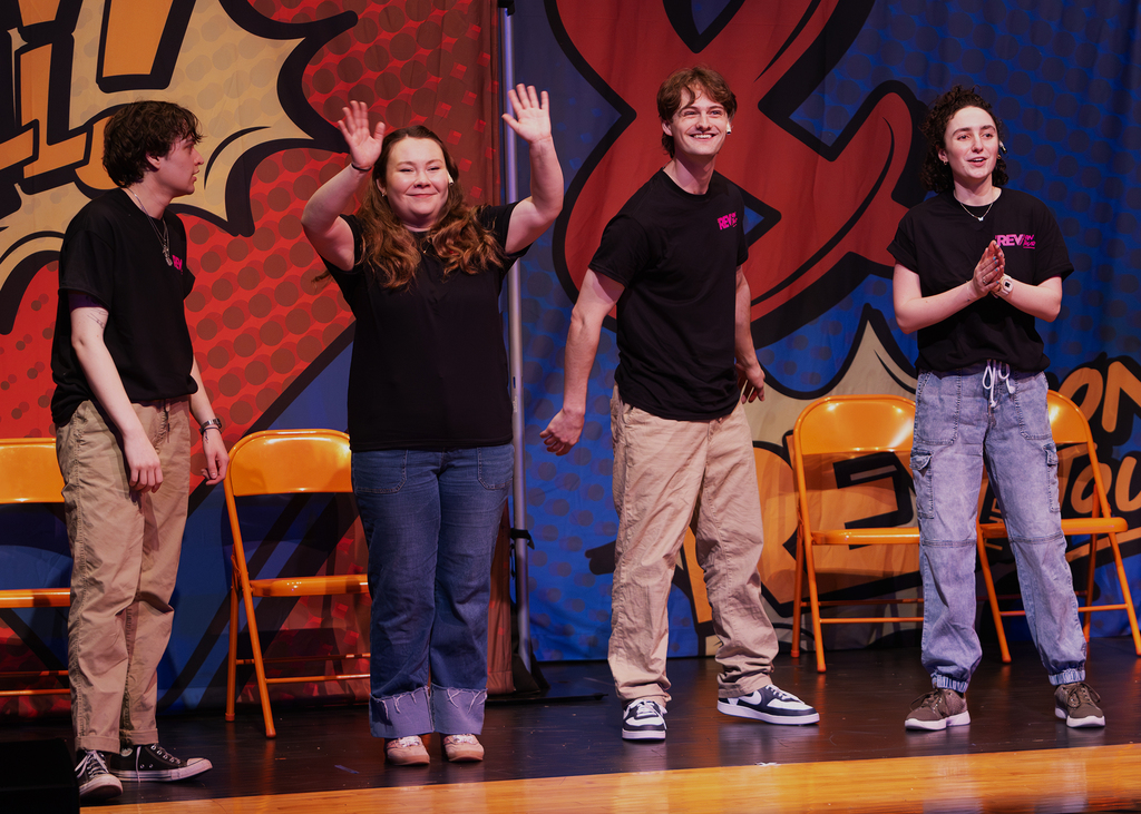 The REV cast on stage performing