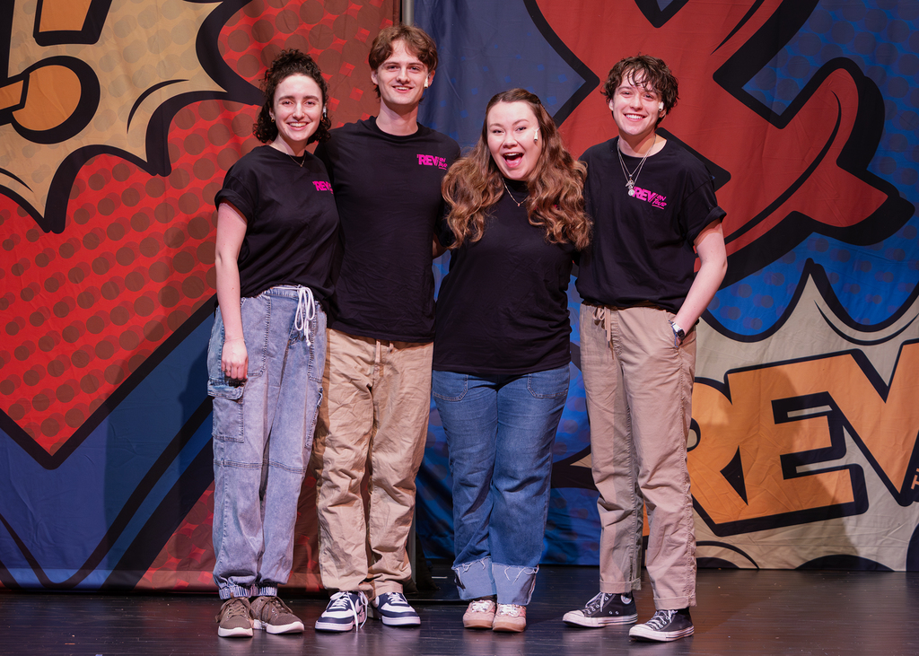 The REV cast on stage performing
