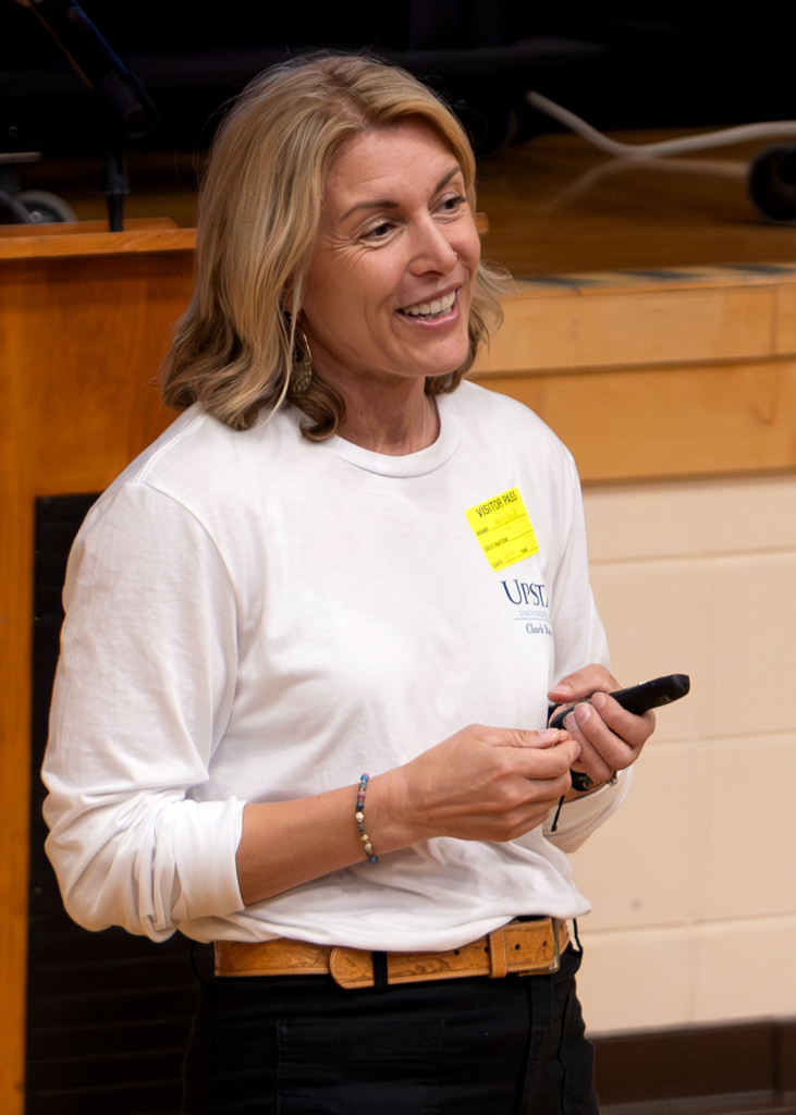 Guest presenter speaks to students in the school auditorium during a fire and burn safety presentation.