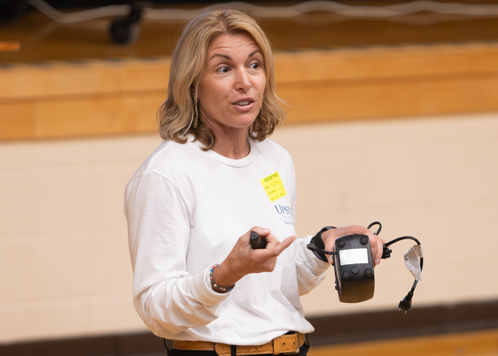 Guest presenter demonstrates an electrical device while discussing household and fire safety topics with students.