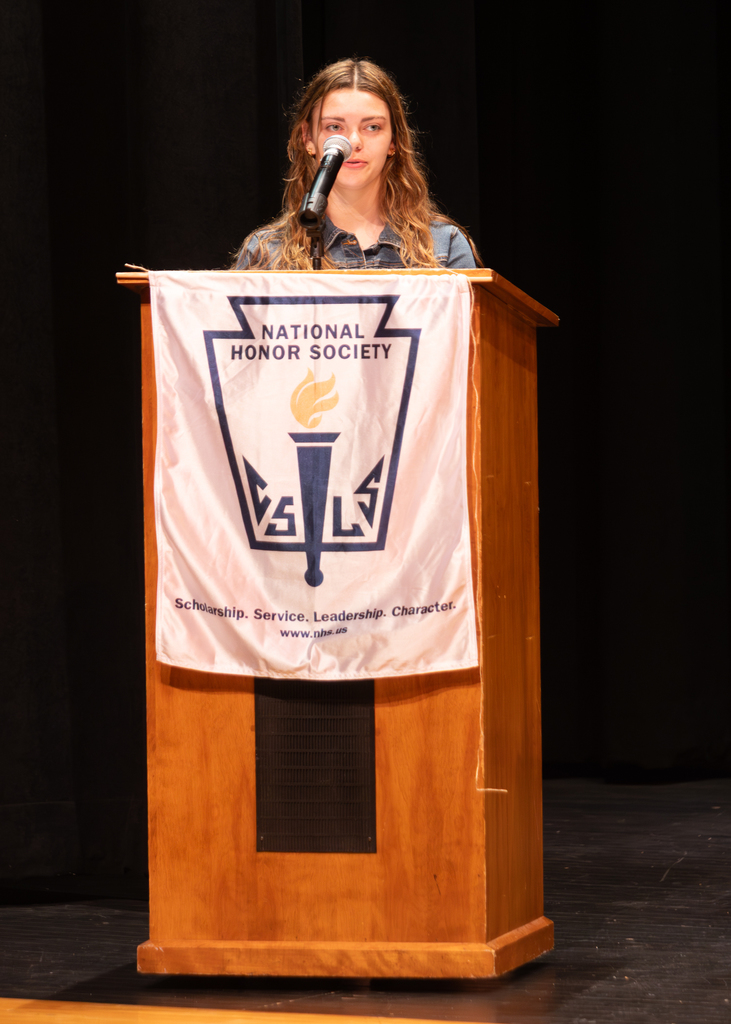 A student stands at the podium