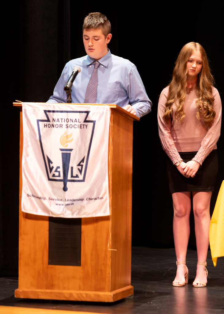A student stands at the podium