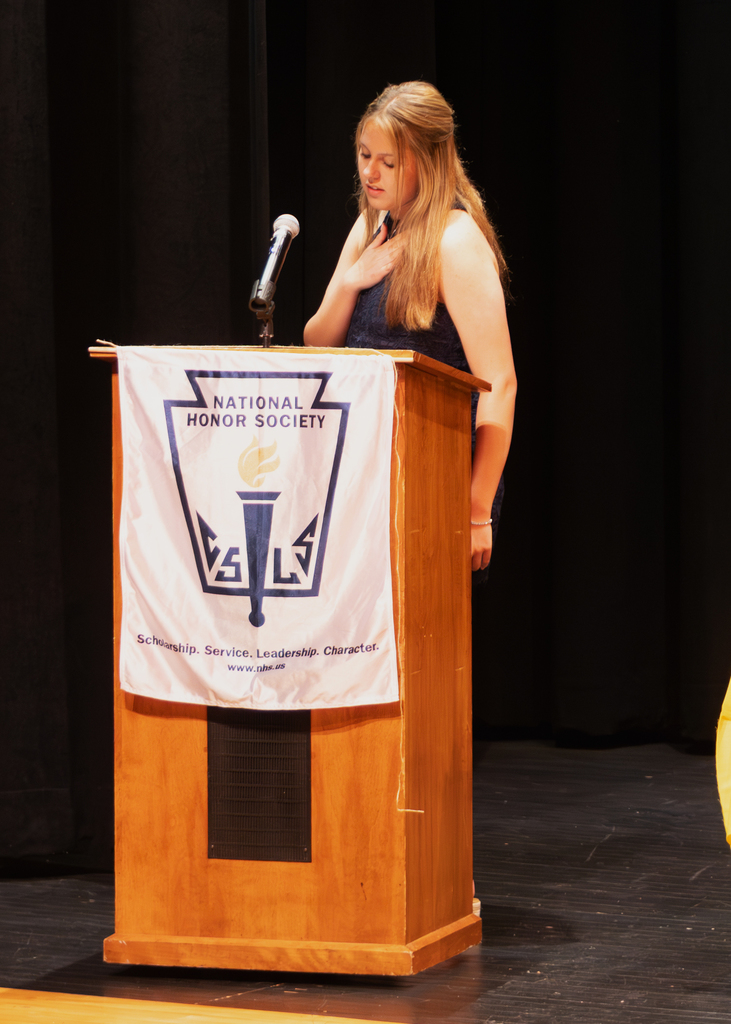 A student stands at the podium