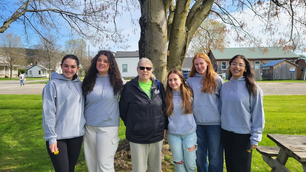 OV students and Colgate mentors gather outdoors for an end-of-year celebration, spending time together and smiling.