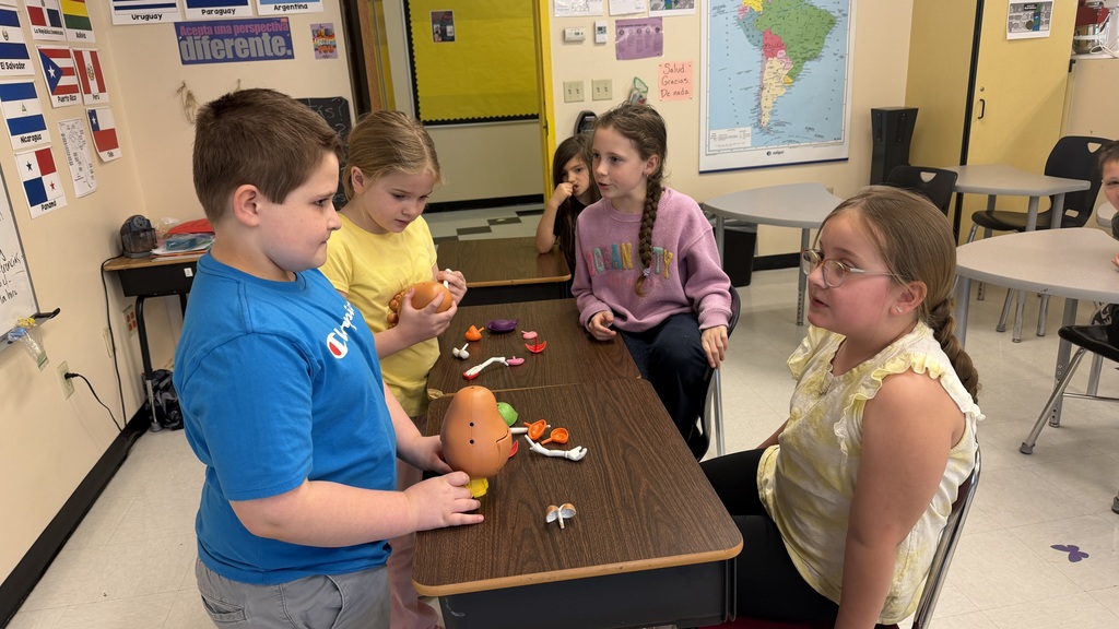 Third grade students participate in interactive Spanish language activities, including games and hands-on learning focused on body parts vocabulary.