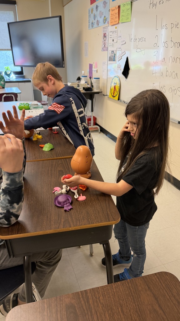 Third grade students participate in interactive Spanish language activities, including games and hands-on learning focused on body parts vocabulary.