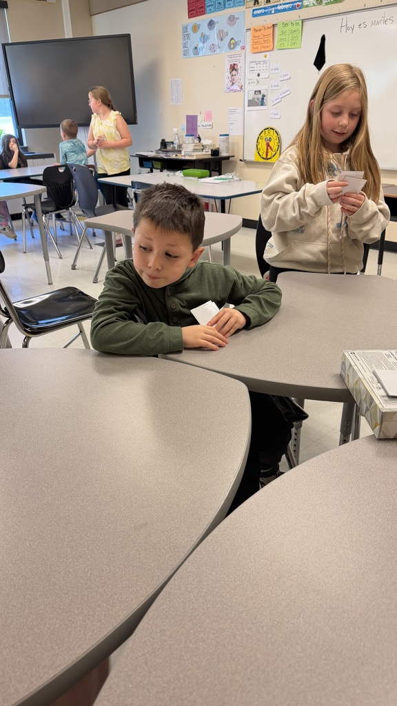 Third grade students participate in interactive Spanish language activities, including games and hands-on learning focused on body parts vocabulary.