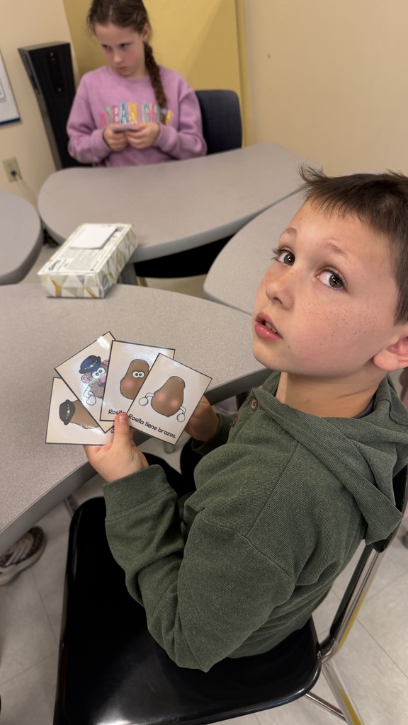 Third grade students participate in interactive Spanish language activities, including games and hands-on learning focused on body parts vocabulary.